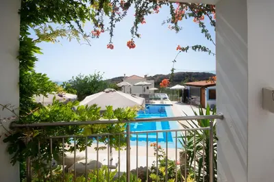 a view from the balcony of a villa with a swimming pool at Infinity Wellness Boutique Hotel in Afráta