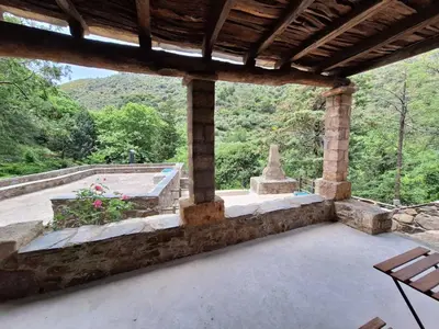 an outdoor patio with a view of a mountain at Μilia Mountain retreat in Vlátos
