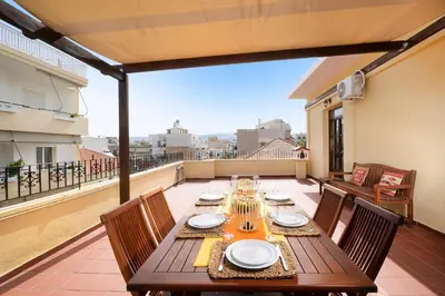 a wooden table on a balcony with a view at Clio Townhouse in Chania Town