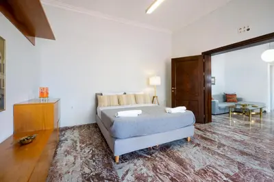a bedroom with a bed and a living room at Clio Townhouse in Chania Town