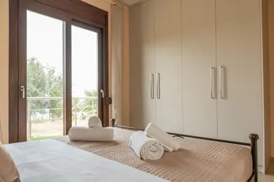 a bedroom with a bed with towels on it at Terra Blue Suites - Dimitra in Kalyves