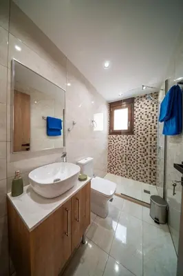 a bathroom with a sink and a toilet at Terra Blue Suites - Dimitra in Kalyves