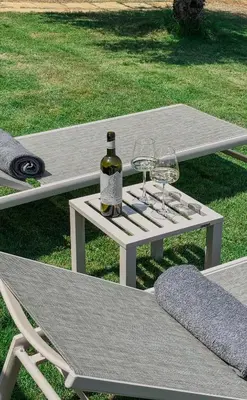 a white picnic table with two glasses and a bottle of wine at Terra Blue Suites - Dimitra in Kalyves