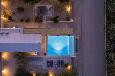 an overhead view of a swimming pool at night at Natura Hill Villa I Sea View in Kounoupidhianá
