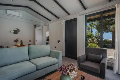 a living room with a couch and two chairs at Natura Hill Villa I Sea View in Kounoupidhianá