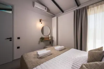 a bedroom with a bed with two towels on it at Natura Hill Villa I Sea View in Kounoupidhianá