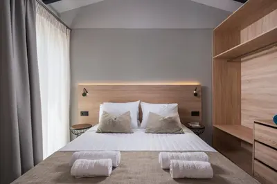 a bedroom with a large bed with two pillows at Natura Hill Villa I Sea View in Kounoupidhianá