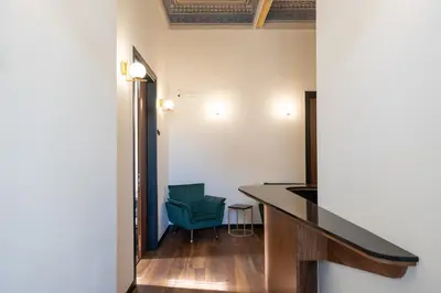 a room with a desk and a green chair at Bouquet Luxury Rooms in Chania Town