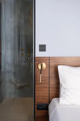 a bedroom with a glass shower and a bed at Bouquet Luxury Rooms in Chania Town