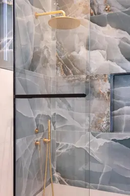 a shower with a glass door with a painting on the wall at Bouquet Luxury Rooms in Chania Town
