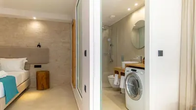 a bathroom with a washer and dryer in a room at D PALM Premium Living - Kalathas, Chania in Chania Town
