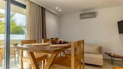 a dining room with a wooden table and chairs at D PALM Premium Living - Kalathas, Chania in Chania Town