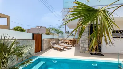 a patio with a swimming pool and a house at D PALM Premium Living - Kalathas, Chania in Chania Town