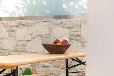 a bowl of fruit sitting on a wooden table at D PALM Premium Living - Kalathas, Chania in Chania Town