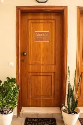 a wooden door with a sign on it at Maria's House in Chania in Kounoupidhianá