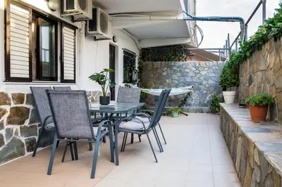 a table and chairs on an outdoor patio at Maria's House in Chania in Kounoupidhianá