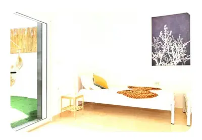 a white bedroom with a bed and a window at Cretan Fun in Stalos