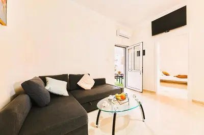 a living room with a couch and a glass table at Cretan Fun in Stalos