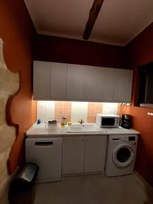 a kitchen with a sink and a washing machine at Pool Villa Kamara Crete - Chania in Chania Town