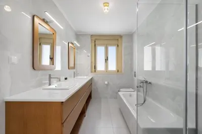 a bathroom with two sinks and a tub and a shower at Villa Athena - Crete Pickleball Paradise in Vamos