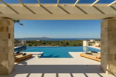 an external view of a villa with a swimming pool at Villa Athena - Crete Pickleball Paradise in Vamos