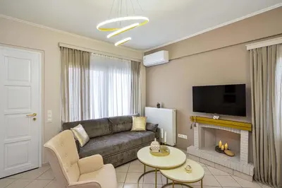 a living room with a couch and a fireplace at La Fleur in Chania Town