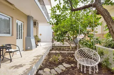 a patio with two chairs and a tree at La Fleur in Chania Town