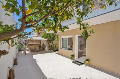 an internal courtyard of a house with a tree at La Fleur in Chania Town
