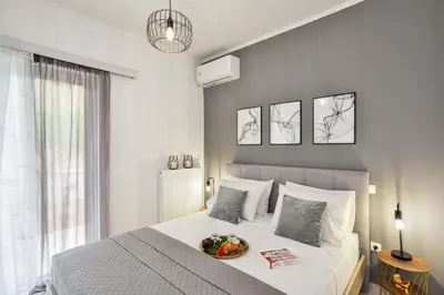 a bedroom with a bed with a bowl of fruit on it at La Fleur in Chania Town
