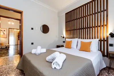 a bedroom with a large bed with towels on it at Chania Dream House in Chania Town