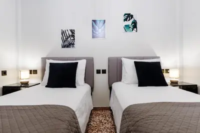 two beds sitting next to each other in a room at Chania Dream House in Chania Town