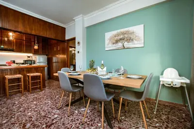 a dining room with a wooden table and chairs at Chania Dream House in Chania Town