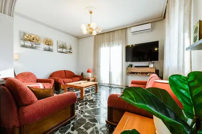 a living room with red furniture and a tv at Chania Dream House in Chania Town
