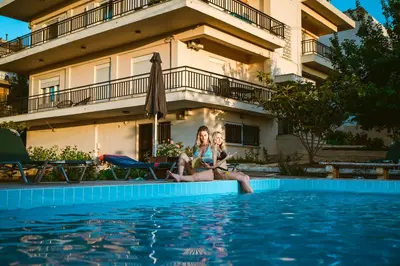 two girls sitting in the pool at a hotel at Chania Dream House in Chania Town