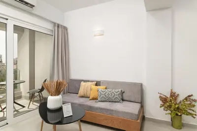 a living room with a couch and a table at Elia City Apartments in Chania Town