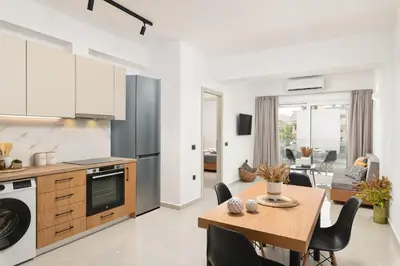 a kitchen and living room with a table and a dining room at Elia City Apartments in Chania Town