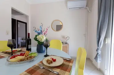 a table with a plate of food and wine glasses at Κidonias home in Chania Town