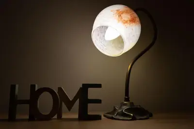 a lamp on a table next to a hmg sign at Κidonias home in Chania Town