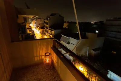 a light on the ledge of a balcony at night at Κidonias home in Chania Town