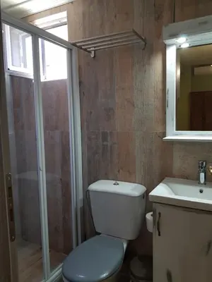 a bathroom with a toilet and a sink and a mirror at Poppy Beloni in Chania Town
