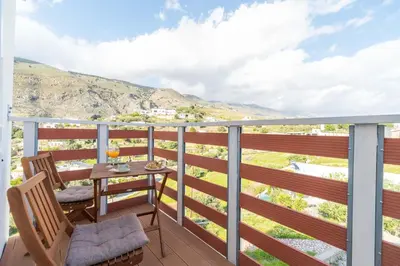 a balcony with a table and chairs with a view at Avra Sfakia Apartments in Khóra Sfakíon