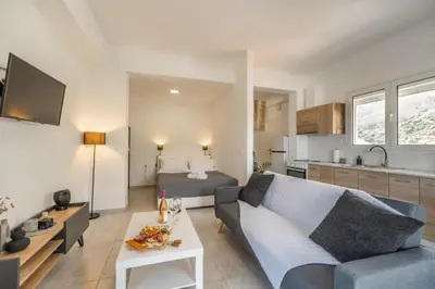 a living room with a couch and a bed at Avra Sfakia Apartments in Khóra Sfakíon