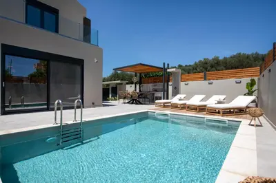 a swimming pool in the backyard of a house at Tersus Luxury Villa in Kalyves