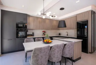 a kitchen with a table with chairs and a kitchen island at Tersus Luxury Villa in Kalyves