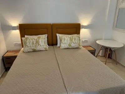 a large bed with two pillows on top of it at Sofia Rooms in Palaiochóra