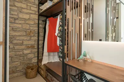 a walk in closet with a stone wall at VILLA PETRA PHILIPPOS heated pool optional in Khámbatha