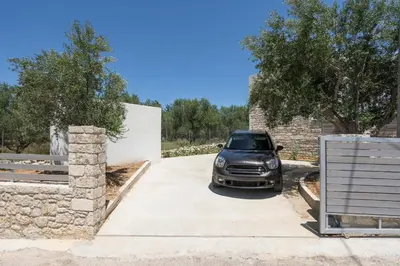 a car parked in the driveway of a house at VILLA PETRA PHILIPPOS heated pool optional in Khámbatha
