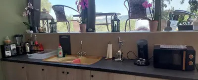 a kitchen counter with a sink and a microwave at Drop of Heaven in Katokhórion