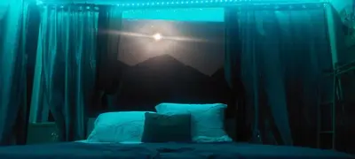 a bedroom with a bed with a mountain projected on a window at Drop of Heaven in Katokhórion