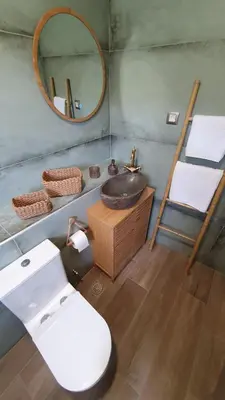 a bathroom with a toilet and a sink and a mirror at Drop of Heaven in Katokhórion